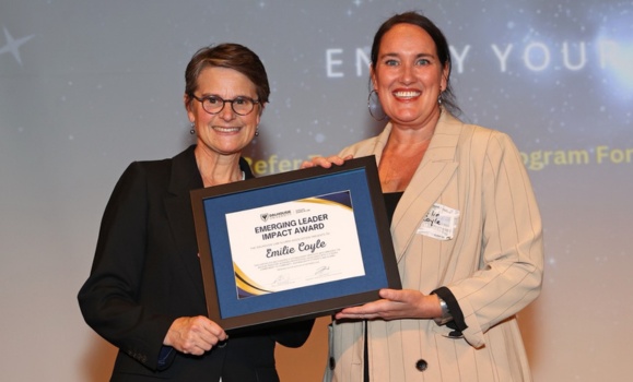 Harding and Coyle pose together with the framed certificate at the event.