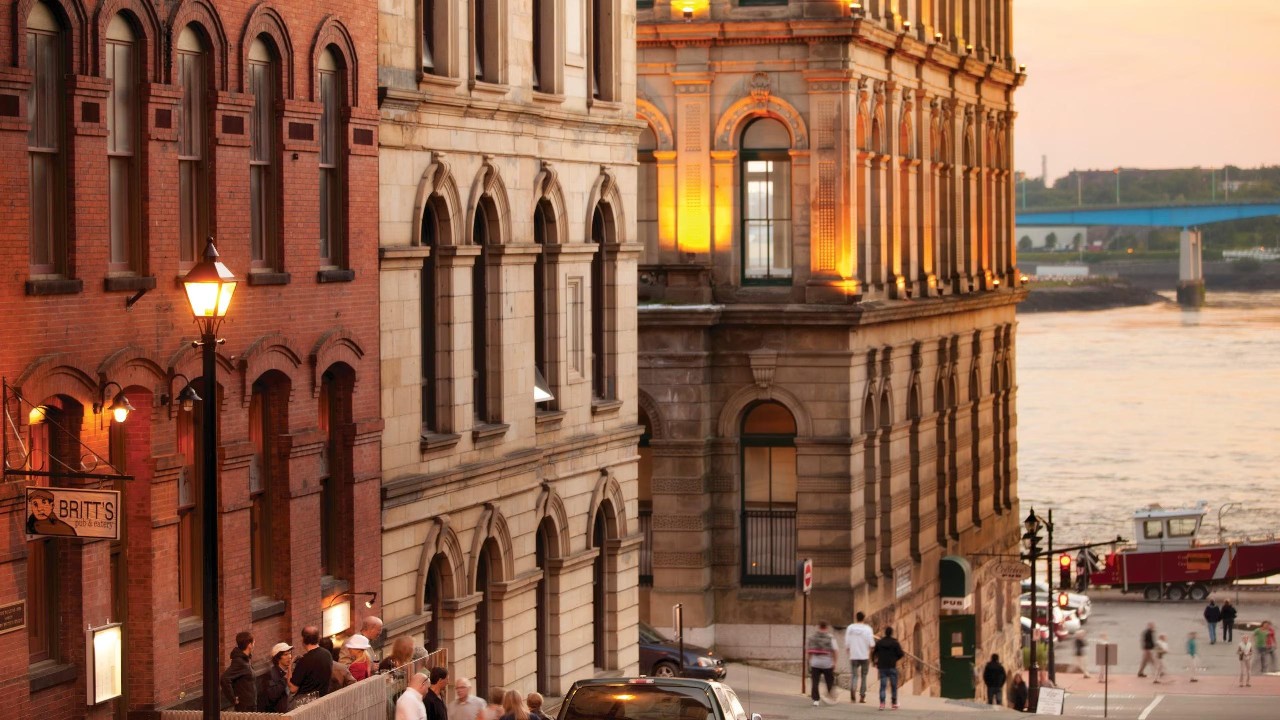 Historic buildings on the Saint John riverfront at sunset.