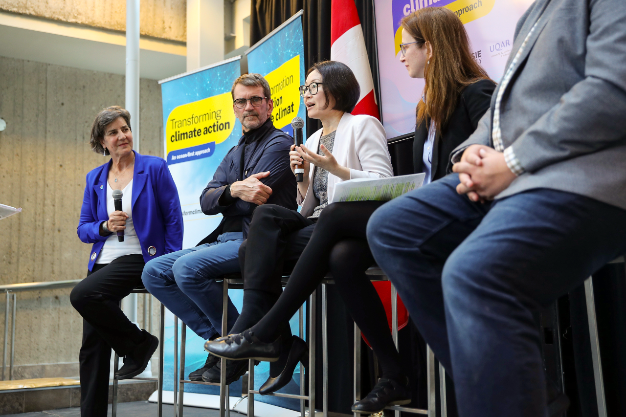 A group of people seated on stage in a discussion
